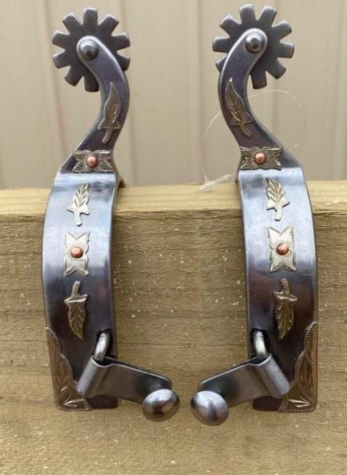 Spur - ® stainless steel spur with leaf overlay.