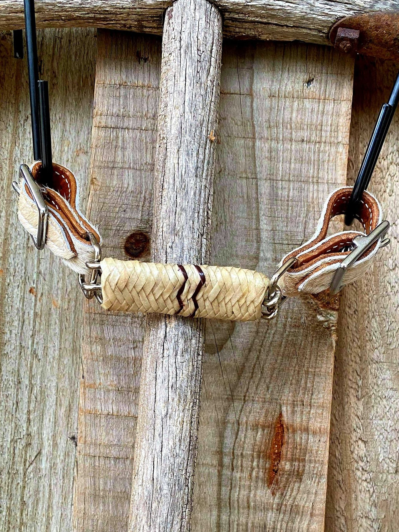 Curb Strap - Curb strap with hair on cowhide ends with rawhide braided covered chain. Adjusts 7" to 9".